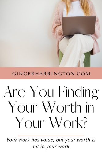 A woman in white pants sits on stool working on computer illustrates article on the temptation to find your worth in your work.
