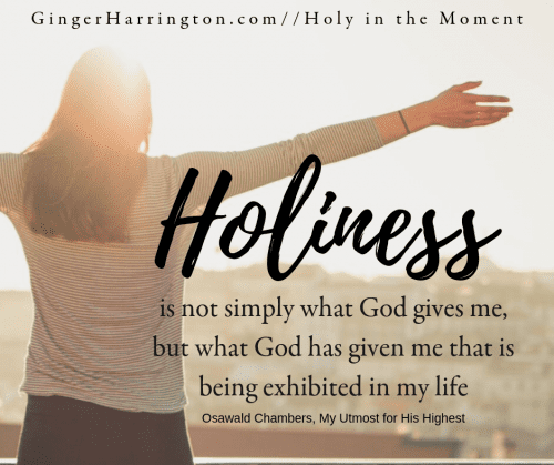 Woman with outstreched arms looks at sunlight as a backdrop for quote on holiness and our life in Christ