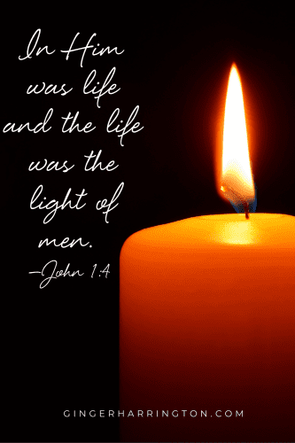 Flame of a red candle against the dark is the background for John 1:4.