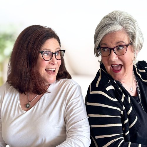 20 Author Ginger Harrington leans on table, holding head in her hand