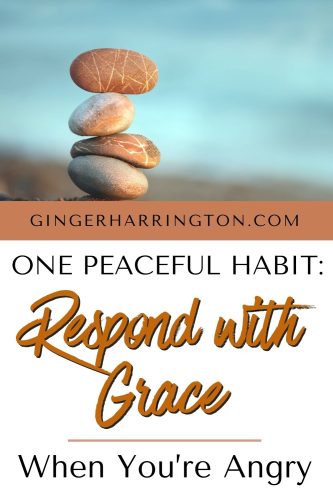 Stack of pebbles by the ocean illustrates article of responding with grace rather than reacting when you feel angry