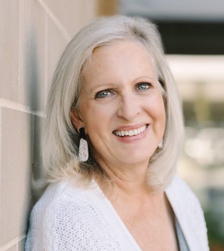 Headshot of Kate Battistelli leaning against a wall